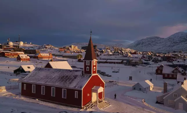 A man walks near the church in Nuuk, Greenland, on Wednesday, Jan. 14, 2026. (AP Photo/Evgeniy Maloletka)