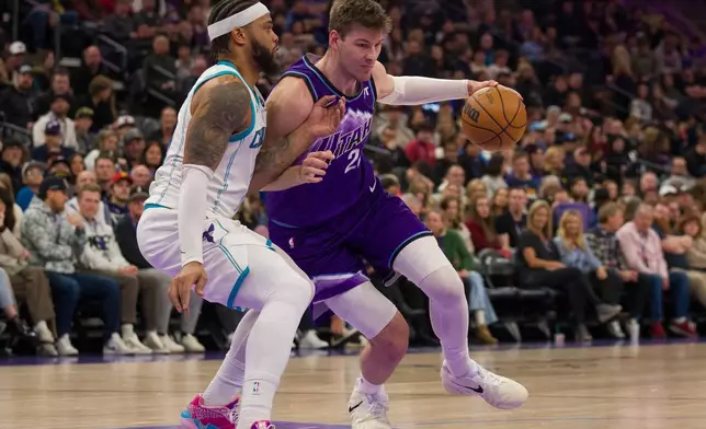 Utah Jazz center Kyle Filipowski (22) drives to the basket as Charlotte Hornets forward Miles Bridges, left, defends during the first half of an NBA basketball game, Saturday, Jan. 10, 2026, in Salt Lake City. (AP Photo/Bethany Baker)