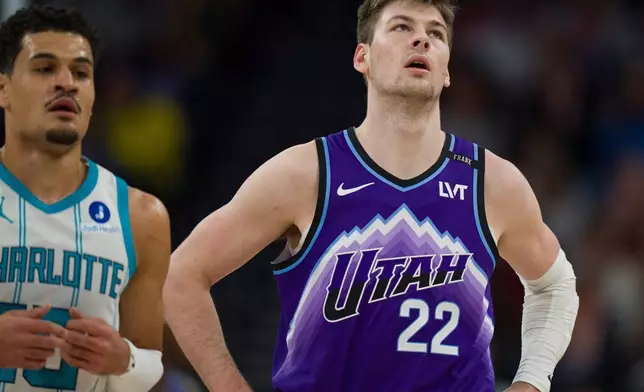 Utah Jazz center Kyle Filipowski (22) reacts as Charlotte Hornets guard Josh Green comes down the court during the first half of an NBA basketball game, Saturday, Jan. 10, 2026, in Salt Lake City. (AP Photo/Bethany Baker)