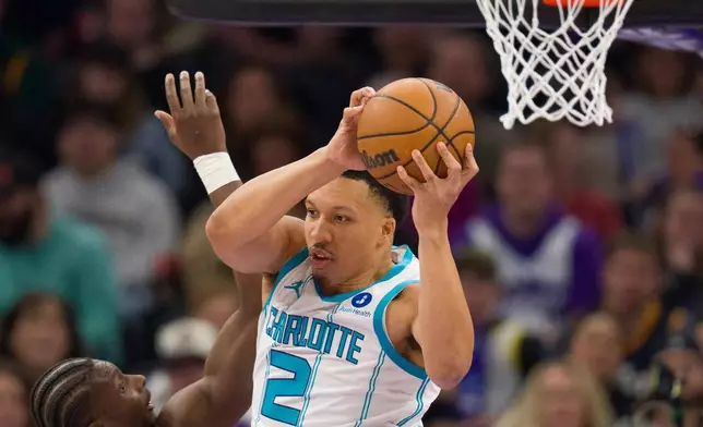 Charlotte Hornets forward Grant Williams (2) catches a rebound as Hornets forward Moussa Diabaté, left, assists during the first half of an NBA basketball game against the Utah Jazz, Saturday, Jan. 10, 2026, in Salt Lake City. (AP Photo/Bethany Baker)