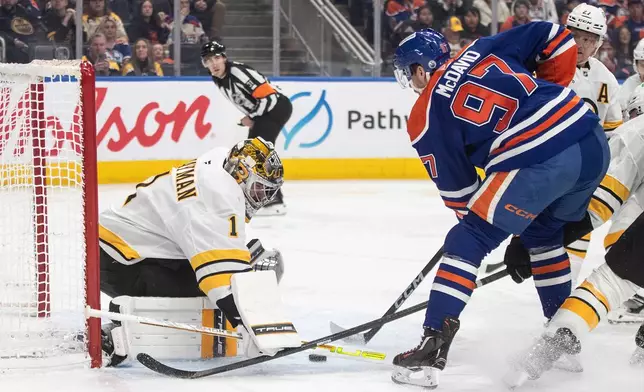 Boston Bruins' goalie Jeremy Swayman (1) makes a save on Edmonton Oilers' Connor McDavid (97) during the second period of an NHL hockey game, in Edmonton, Alberta, Wednesday, Dec. 31, 2025. (Jason Franson/The Canadian Press via AP)