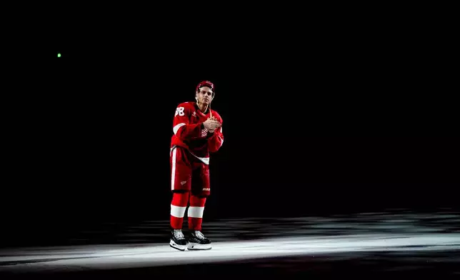 Detroit Red Wings right wing Patrick Kane greets fans after the team's win in NHL hockey game against the Vancouver Canucks after he scored his 500th career goal Thursday, Jan. 8, 2026, in Detroit. (AP Photo/Ryan Sun)