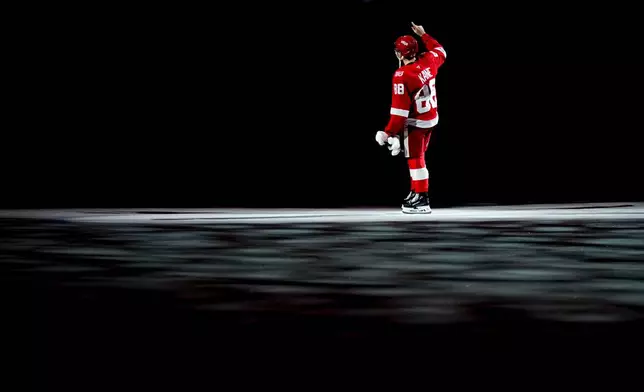 Detroit Red Wings right wing Patrick Kane celebrates after the team's win against the Vancouver Canucks in an NHL hockey game after scoring his 500th career goal Thursday, Jan. 8, 2026, in Detroit. (AP Photo/Ryan Sun)