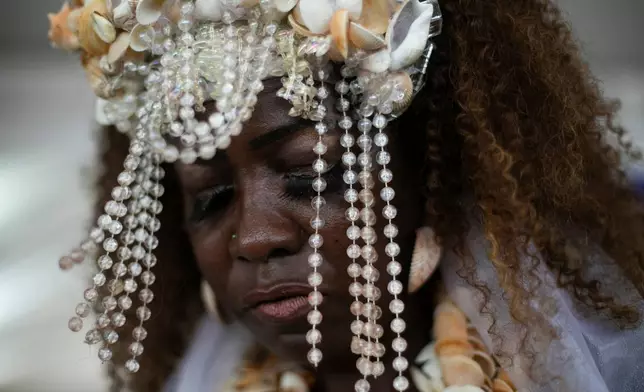 FILE - A devotee dances during a ceremony honoring Yemanja, the sea goddess of the Yoruba religion, on Copacabana Beach in Rio de Janeiro, Dec. 29, 2025. (AP Photo/Bruna Prado, File)