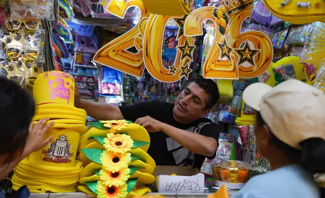 FILE - A vendor sells New Year's eve party goods at a market in downtown Lima, Peru, Dec. 30, 2025. (AP Photo/Guadalupe Pardo, File)