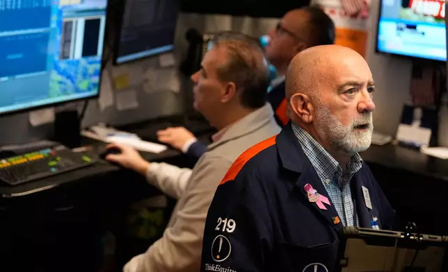 Joseph Stevens works on the floor at the New York Stock Exchange in New York, Tuesday, Jan. 6, 2026. (AP Photo/Seth Wenig)