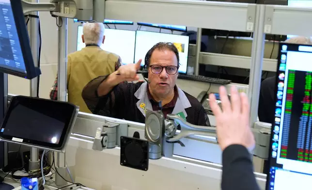Anthony Spina works on the floor at the New York Stock Exchange in New York, Tuesday, Jan. 6, 2026. (AP Photo/Seth Wenig)