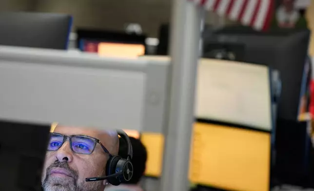 Steven Rodriguez works on the floor at the New York Stock Exchange in New York, Tuesday, Jan. 6, 2026. (AP Photo/Seth Wenig)