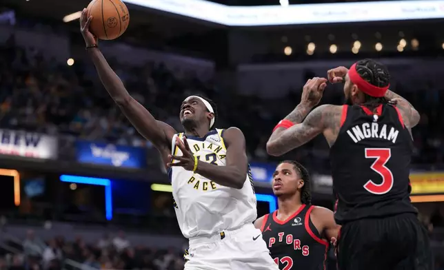 Indiana Pacers forward Pascal Siakam (43) shoots between Toronto Raptors defenders Collin Murray-Boyles (12) and Brandon Ingram (3) during the first half of an NBA basketball game in Indianapolis, Wednesday, Jan. 14, 2026. (AP Photo/AJ Mast)