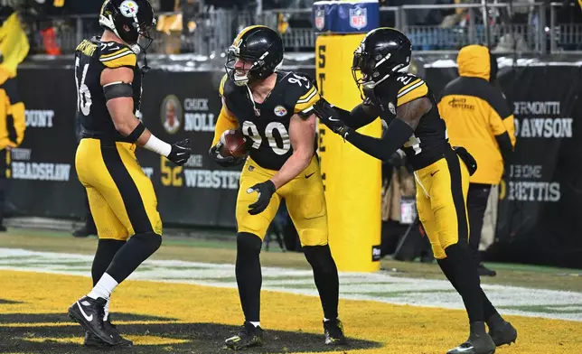 Pittsburgh Steelers outside linebacker T.J. Watt (90) celebrates with teammates after an interception during the second half an NFL football game against the Baltimore Ravens, Sunday, Jan. 4, 2026, in Pittsburgh. (AP Photo/Justin Berl)