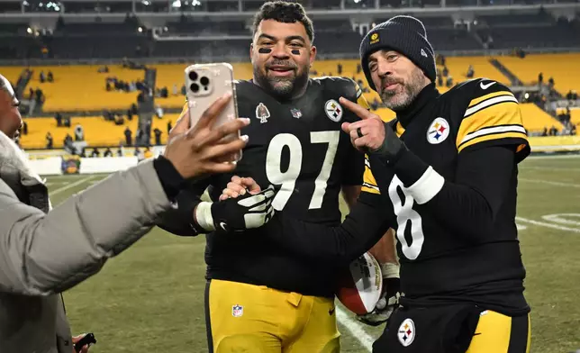 Pittsburgh Steelers quarterback Aaron Rodgers stands with defensive tackle Cameron Heyward (97) after an NFL football game against the Baltimore Ravens, Sunday, Jan. 4, 2026, in Pittsburgh. (AP Photo/Justin Berl)