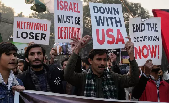 Shiite Muslims hold placards and chant slogans during a protest against the U.S. and show solidarity with Iran in Lahore, Pakistan, Sunday, Jan. 11, 2026. (AP Photo/K.M. Chaudary)