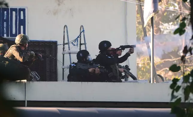 Security forces enter the Renovation maximum-security prison to free guards taken hostage and retake control of the facility, which houses gang leaders, in Escuintla, Guatemala, Sunday, Jan. 18, 2026. (AP Photo/Moises Castillo)