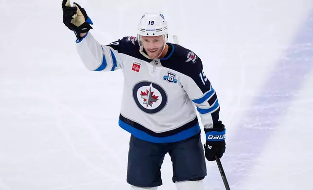 Winnipeg Jets center Jonathan Toews waves to the crowd during the first period of an NHL hockey game against the Chicago Blackhawks in Chicago, Monday, Jan. 19, 2026. (AP Photo/Nam Y. Huh)
