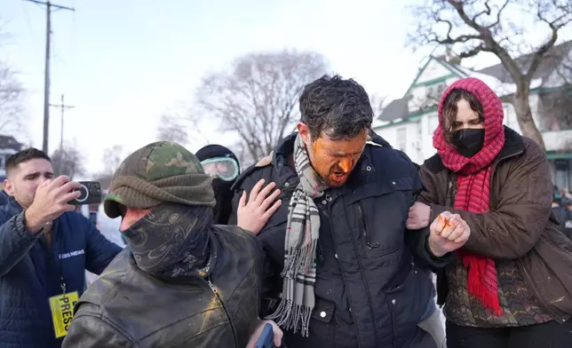Protestors react after being hit with chemical spray at the scene of a shooting in Minneapolis, on Wednesday, Jan. 7, 2026. (Alex Kormann/Star Tribune via AP)