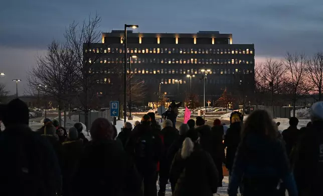 Protesters gather outside the Bishop Henry Whipple Federal Building, Thursday, Jan. 8, 2026, in Minneapolis, Minn. (AP Photo/Tom Baker)