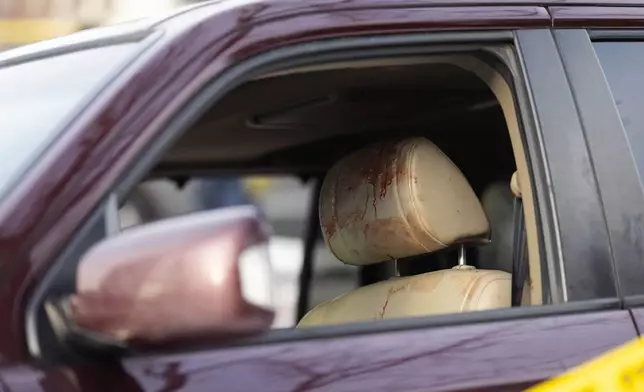 Blood is seen on the headrest of a vehicle at the scene of a shooting in Minneapolis on Wednesday, Jan. 7, 2026. (Ben Hovland /Minnesota Public Radio via AP)