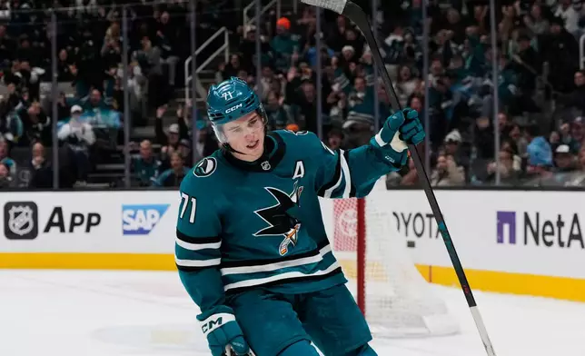 San Jose Sharks center Macklin Celebrini celebrates after scoring in the shoot-out of an NHL hockey game against the Minnesota Wild, Wednesday, Dec. 31, 2025, in San Jose, Calif. (AP Photo/Godofredo A. Vásquez)