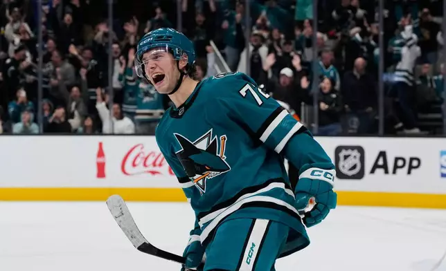 San Jose Sharks left wing William Eklund, left, celebrates after scoring a goal in the shoot-out of an NHL hockey game against the Minnesota Wild, Wednesday, Dec. 31, 2025, in San Jose, Calif. (AP Photo/Godofredo A. Vásquez)