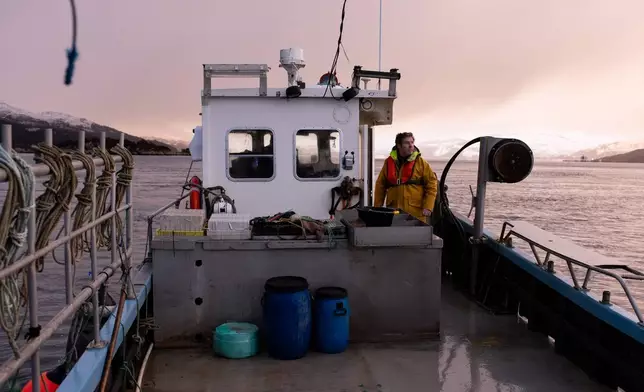 Bally Philp looks out at the loch for the buoy marking his creels on Nov. 20, 2025, in Loch Alsh off the coast of Kyleakin, Scotland. (AP Photo/Emily Whitney)