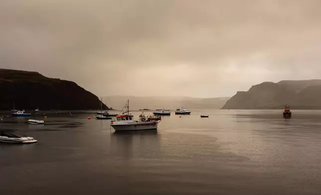 Creel fishing boats, tour boats and others dock at the harbor on Nov. 22, 2025, in Portree, Scotland. (AP Photo/Emily Whitney)