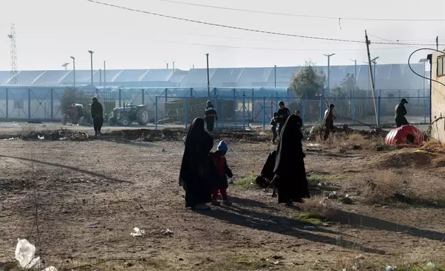 People walk inside the al-Hol camp in northeastern Syria's Hasakeh province, Syria, Wednesday, Jan. 21, 2026, after the withdrawal of the Syrian Democratic Forces (SDF). (AP Photo/Ghaith Alsayed)