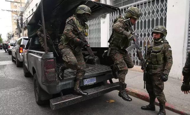 Deployed soldiers exit a vehicle around Congress in Guatemala City, Monday, Jan. 19, 2026, after President Bernardo Arévalo declared a state of emergency. (AP Photo/Moises Castillo)