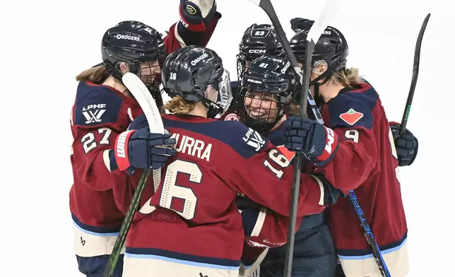 Montreal Victoire's Maureen Murphy (21) celebrates with teammates Hayley Scamurra (16) Shiann Darkangelo (27), Erin Ambrose (23) and Kati Tabin (9) after scoring against the Ottawa Charge during first period PWHL hockey action in Laval, Quebec, Canada, Saturday, Jan. 24, 2026. (Graham Hughes/The Canadian Press via AP)