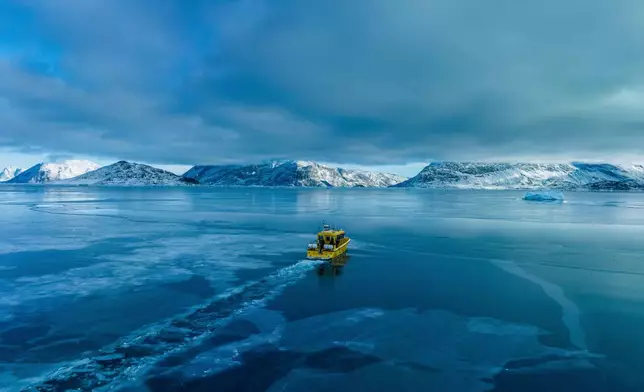 FILE - A boat rides though a frozen sea inlet outside of Nuuk, Greenland, on March 6, 2025. (AP Photo/Evgeniy Maloletka, File)