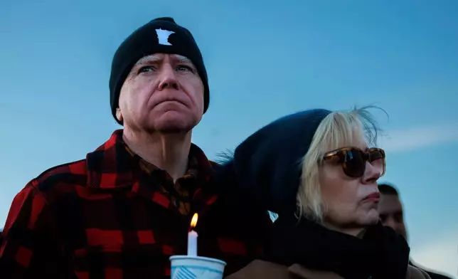 Minnesota Gov. Tim Walz and his wife, Gwen Walz, attend a vigil honoring Renee Good on Friday, Jan. 9, 2026, in St. Paul, Minn., outside the Minnesota State Capitol. (Kerem Yücel/Minnesota Public Radio via AP)