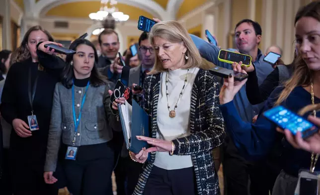 With a partial government shutdown looming by week's end, Sen. Lisa Murkowski, R-Alaska, a member of the Senate Appropriations Committee, is surrounded by reporters following a closed-door Republican meeting on spending legislation that funds the Department of Homeland Security and a swath of other government agencies as the country reels from the deaths of two people at the hands of federal agents in Minneapolis, at the Capitol in Washington, Wednesday, Jan. 28, 2026. (AP Photo/J. Scott Applewhite)