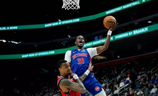 Detroit Pistons guard Javonte Green, right, shoots against Los Angeles Clippers forward John Collins during the first half of an NBA basketball game Saturday, January 10, 2026, in Detroit. (AP Photo/Ryan Sun)