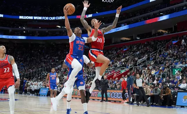 Detroit Pistons guard Jaden Ivey (23) shoots against Los Angeles Clippers forward John Collins (20) during the first half of an NBA basketball game, Saturday, Jan. 10, 2026, in Detroit. (AP Photo/Ryan Sun)