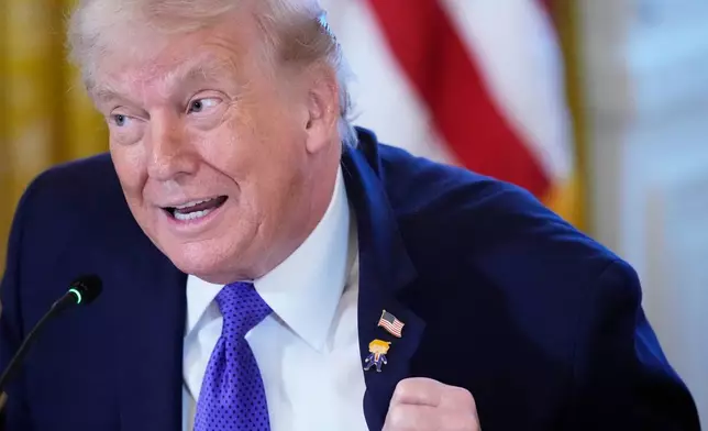 President Donald Trump wears a gift, which he calls a "Happy Trump" pin, during a meeting with oil executives in the East Room of the White House, Friday, Jan. 9, 2026, in Washington. (AP Photo/Alex Brandon)