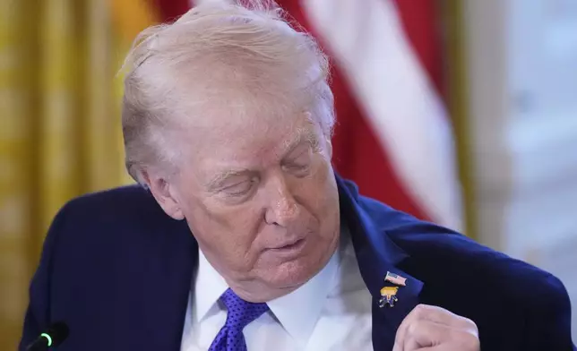 President Donald Trump wears a gift, which he calls a "Happy Trump" pin, during a meeting with oil executives in the East Room of the White House, Friday, Jan. 9, 2026, in Washington. (AP Photo/Alex Brandon)