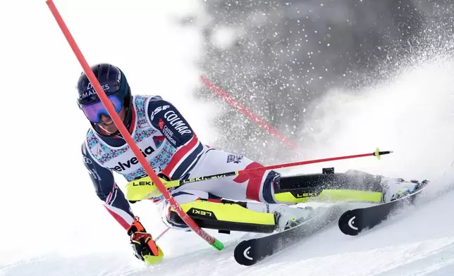 France's Paco Rassat speeds down the course during an alpine ski, men's World Cup slalom, in Adelboden, Switzerland, Sunday, Jan. 11, 2026. (AP Photo/Giovanni Zenoni)