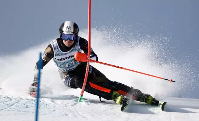 Finland's Eduard Hallberg speeds down the course during an alpine ski, men's World Cup slalom, in Adelboden, Switzerland, Sunday, Jan. 11, 2026. (AP Photo/Gabriele Facciotti)