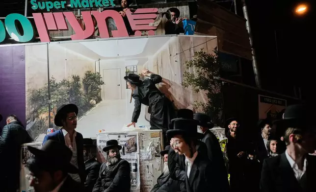 Ultra-Orthodox Jewish men protest against army recruitment in Jerusalem, Tuesday, Jan. 6, 2026. (AP Photo/Ohad Zwigenberg)