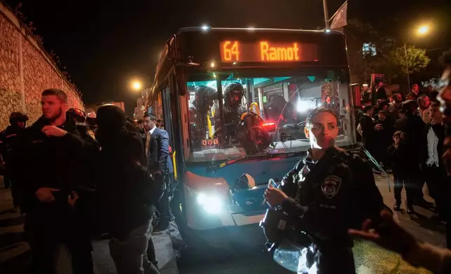 Israeli police inspect a bus following an incident in which it hit ultra-Orthodox Jewish demonstrators blocking a road during a protest against army recruitment in Jerusalem, Tuesday, Jan. 6, 2026. (AP Photo/Ohad Zwigenberg)