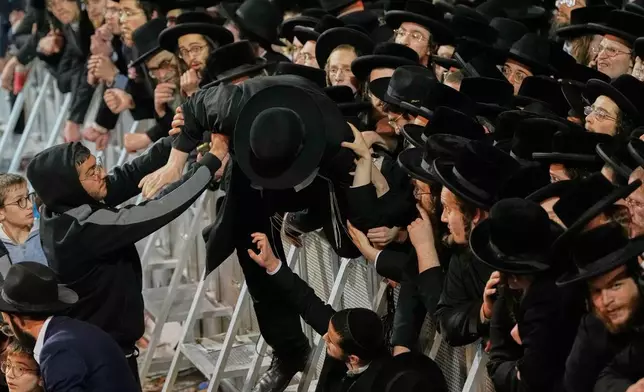Ultra-Orthodox Jewish men protest against army recruitment in Jerusalem, Tuesday, Jan. 6, 2026. (AP Photo/Ohad Zwigenberg)