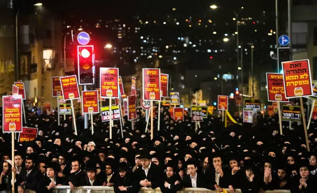 Ultra-Orthodox Jewish men protest against army recruitment in Jerusalem, Tuesday, Jan. 6, 2026. (AP Photo/Ohad Zwigenberg)