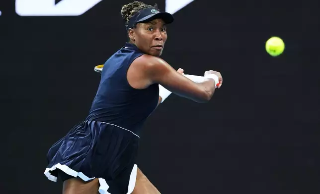Venus Williams of the U.S. plays a backhand return to Olga Danilovic of Serbia during their first round match at the Australian Open tennis championship in Melbourne, Australia, Sunday, Jan. 18, 2026. (AP Photo/Aaron Favila)