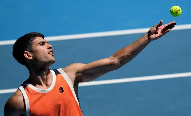 Carlos Alcaraz of Spain serves during a practice session ahead of the Australian Open tennis championship in Melbourne, Australia, Saturday, Jan. 17, 2026. (AP Photo/Aaron Favila)