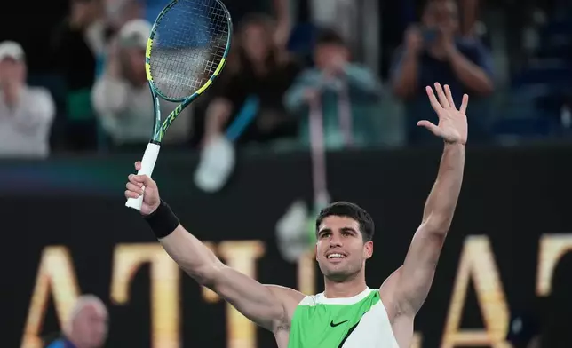 Carlos Alcaraz of Spain celebrates after defeating Adam Walton of Australia in their first round match at the Australian Open tennis championship in Melbourne, Australia, Sunday, Jan. 18, 2026. (AP Photo/Dita Alangkara)