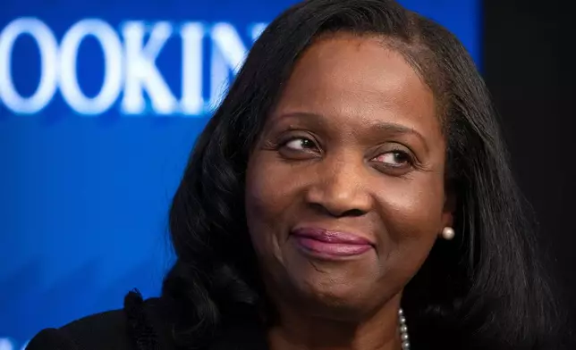 FILE - Lisa Cook, a Federal Reserve Board of Governors member, reacts during an event at the Brookings Institution, Monday, Nov. 3, 2025, in Washington. (AP Photo/Mark Schiefelbein, file)