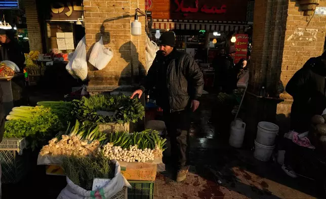 A vendor sells vegetables at the Tajrish bazaar, a market in northern Tehran, Iran, Tuesday, Jan. 27, 2026. (AP Photo/Vahid Salemi)