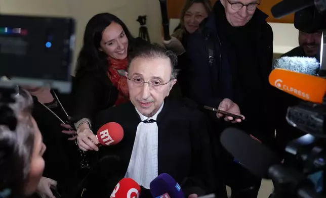 Brigitte Macron's lawyer Jean Ennochi answers reporters after a Paris court has found 10 people guilty of cyberbullying France's first lady, Brigitte Macron by spreading false online claims about her gender and sexuality, Monday, Jan. 5, 2026 in Paris. (AP Photo/Aurelien Morissard)