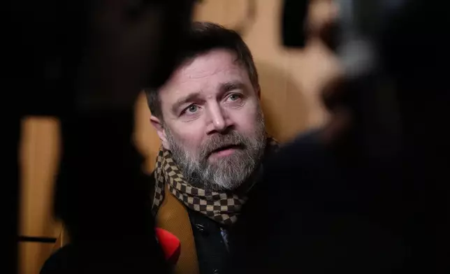 Defendant Bertrand Scholler answers reporters after a Paris court has found 10 people guilty of cyberbullying France's first lady, Brigitte Macron by spreading false online claims about her gender and sexuality, Monday, Jan. 5, 2026 in Paris. (AP Photo/Aurelien Morissard)