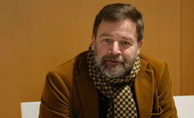 Defendant Bertrand Scholler waits before the verdict in a case involving 10 people accused of cyberbullying French first lady Brigitte Macron by spreading false online claims about her gender and sexuality, Monday, Jan. 5, 2026 in Paris. (AP Photo/Aurelien Morissard)