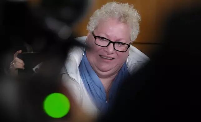 Defendant Delphine Jegousse known as Amandine Roy, answers reporters after a Paris court has found 10 people guilty of cyberbullying France's first lady, Brigitte Macron by spreading false online claims about her gender and sexuality, Monday, Jan. 5, 2026 in Paris. (AP Photo/Aurelien Morissard)